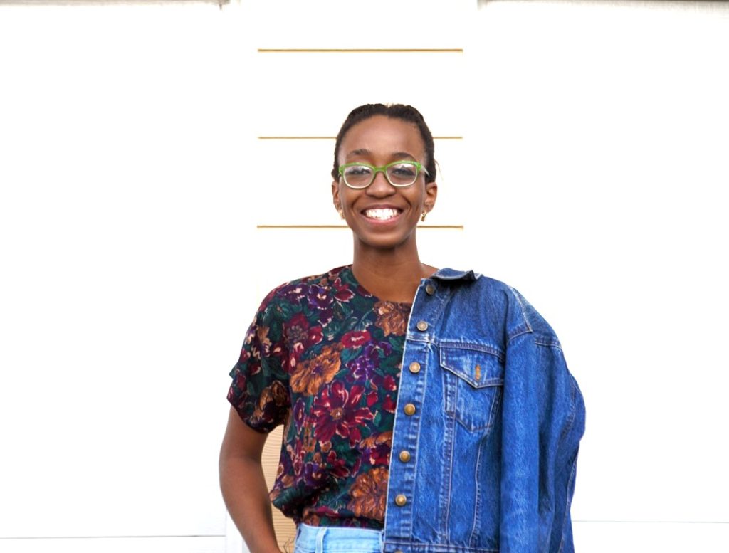 Styling high waisted denim mom shorts, Portrait image of Nigerian fashion blogger Cassie Daves wearing denim jacket and a wide smile