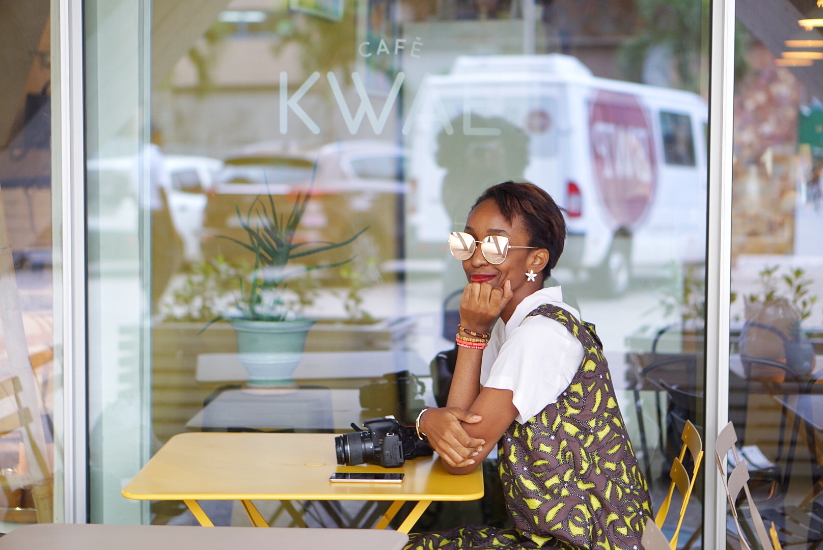 Nigerian Fashion and lifestyle blogger Cassie Daves sitting outdoor at Cafe Kwae in Accra, Ghana