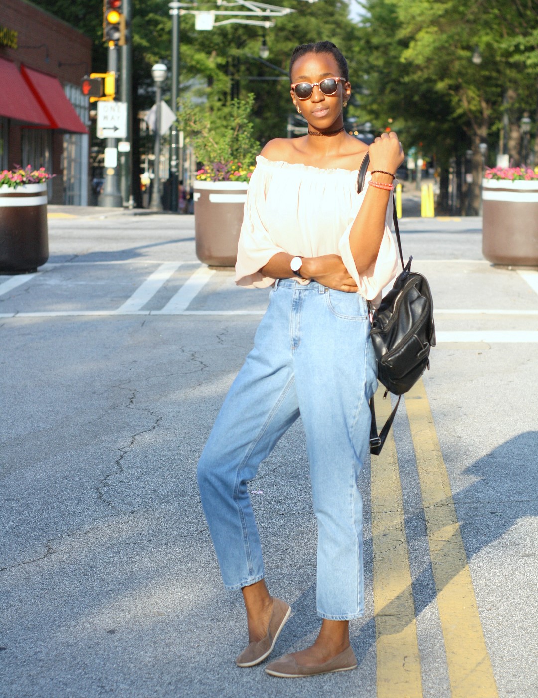 Cassie Daves in blue high waisted jeans with brown flats and off shoulder top