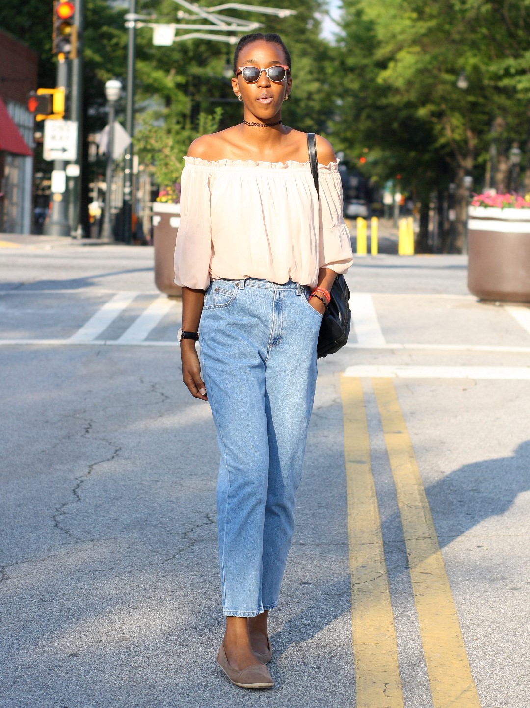 Cassie Daves in brown off shoulder top with blue high waisted denim mom jeans