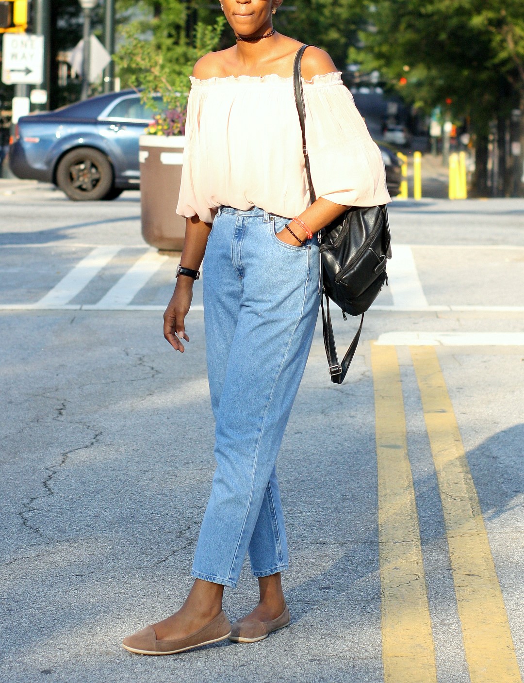 Style blogger Cassie Daves in high waisted jeans with off shoulder top and brown flats