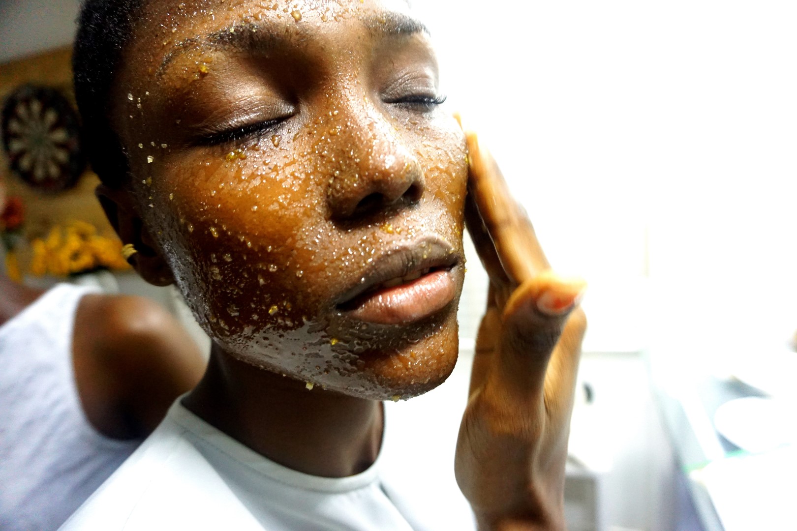 black model using DIY brown sugar and honey face scrub
