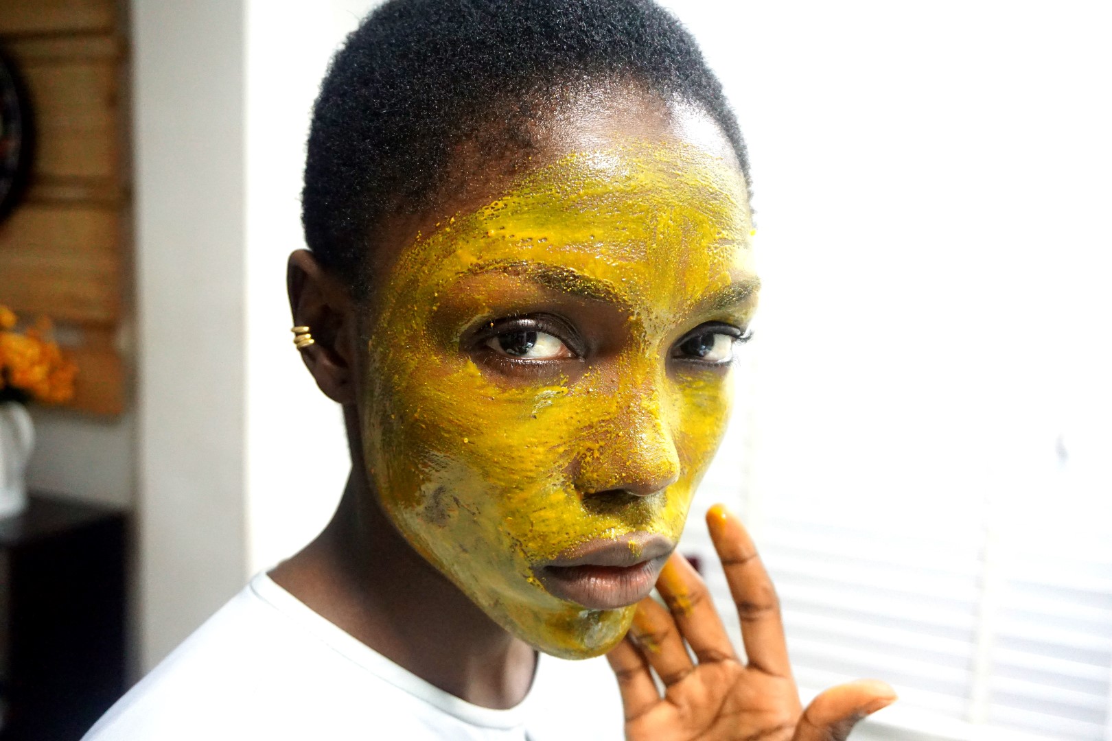 black model using DIY turmeric face mask