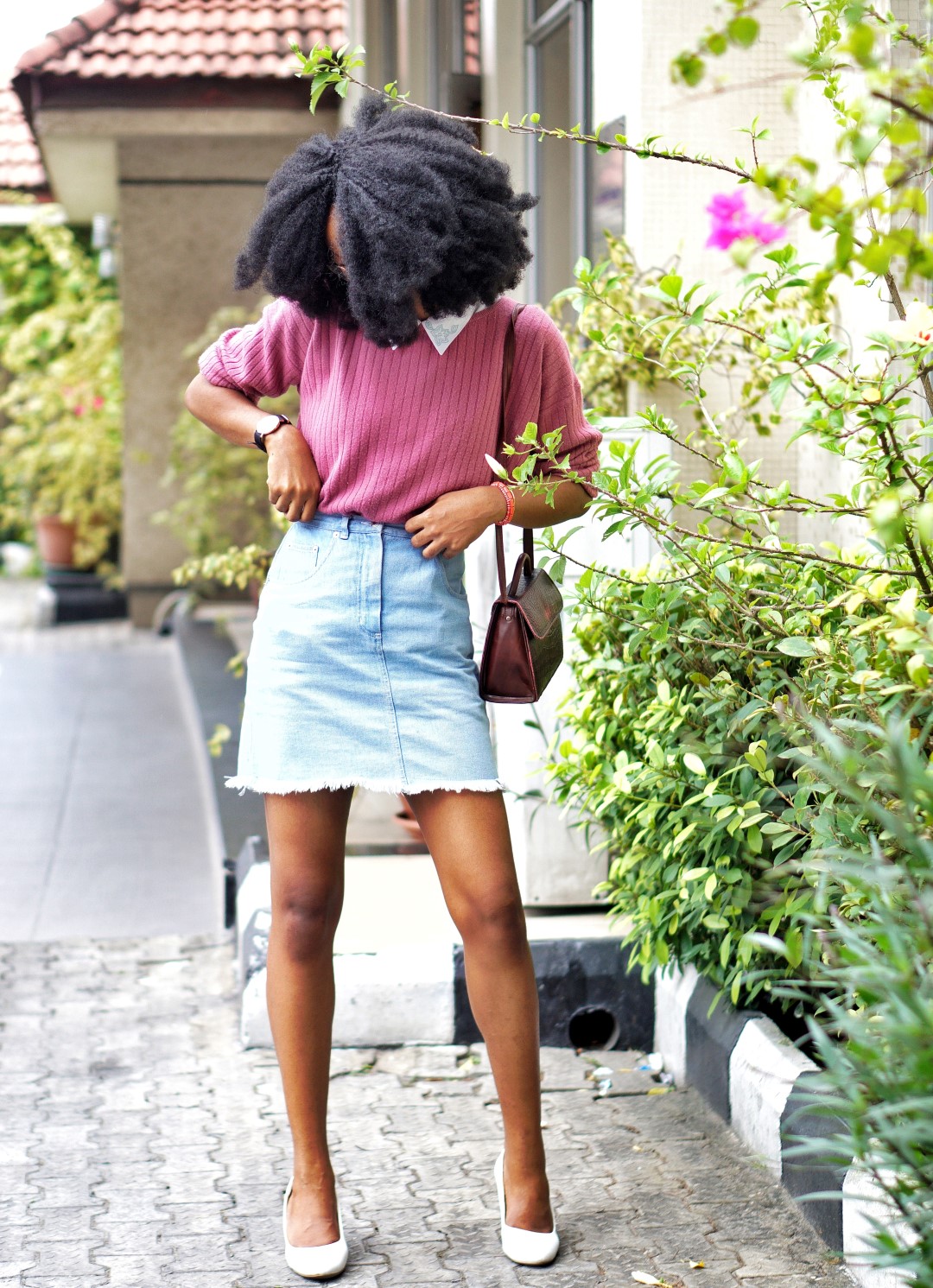 nigerian fashion blogger Cassie daves wearing a denim mini skirt, sweat shirt and white court shoes