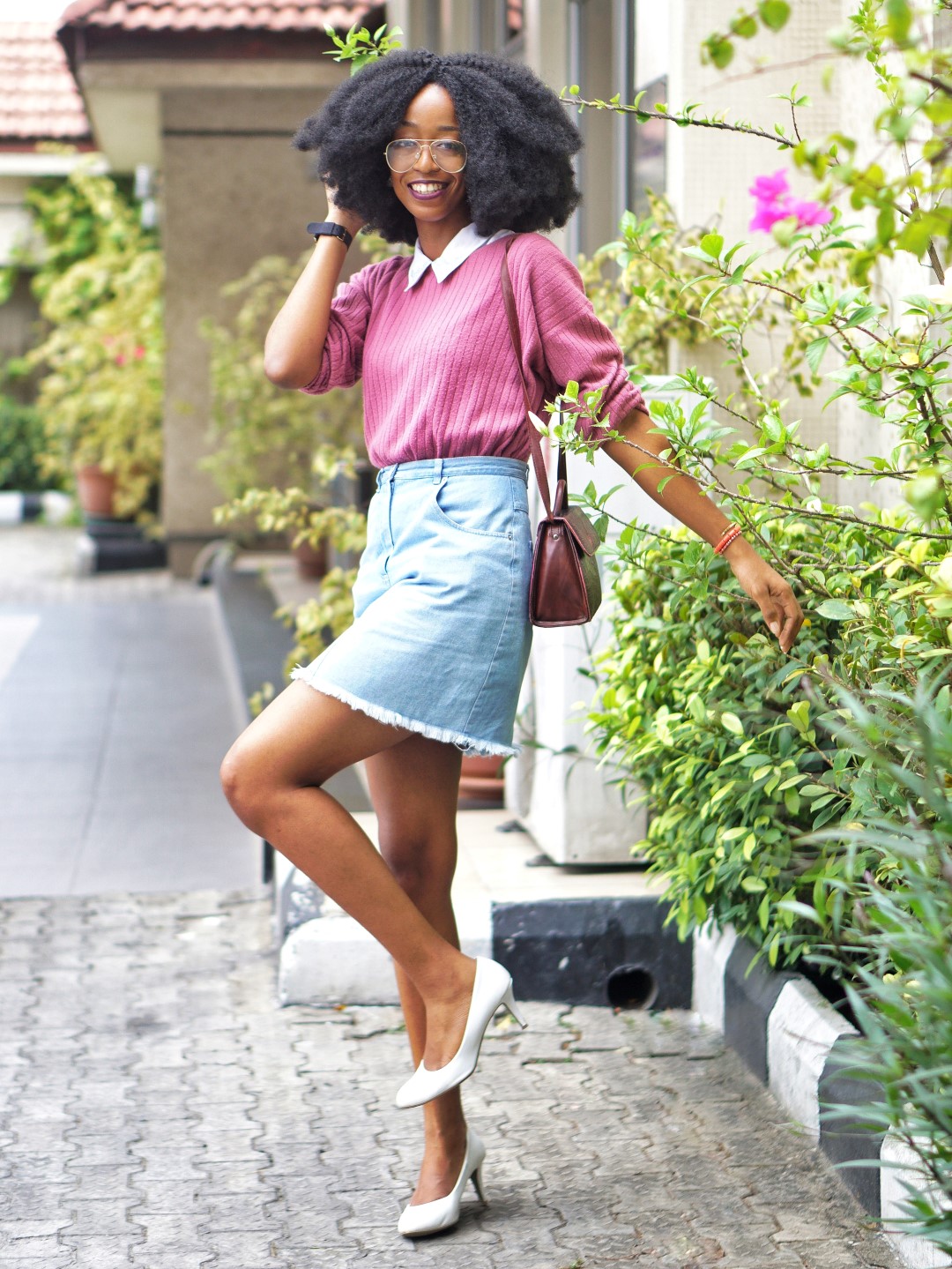 nigerian fashion blogger Cassie daves wearing a denim mini skirt, and white court shoes