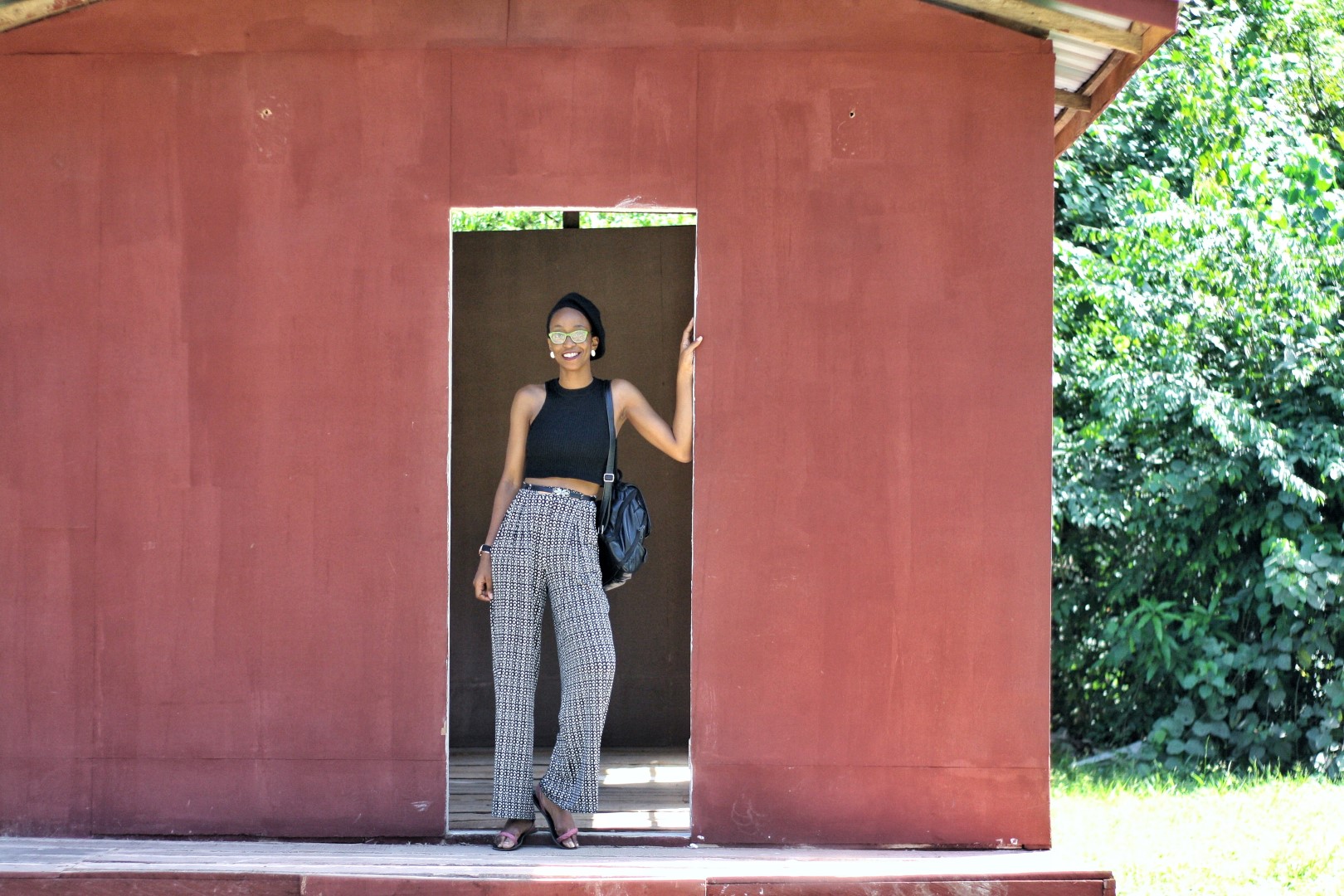 Nigerian fashion blogger Cassie Daves standing at the entrance of an uncompleted building at the lufasi park