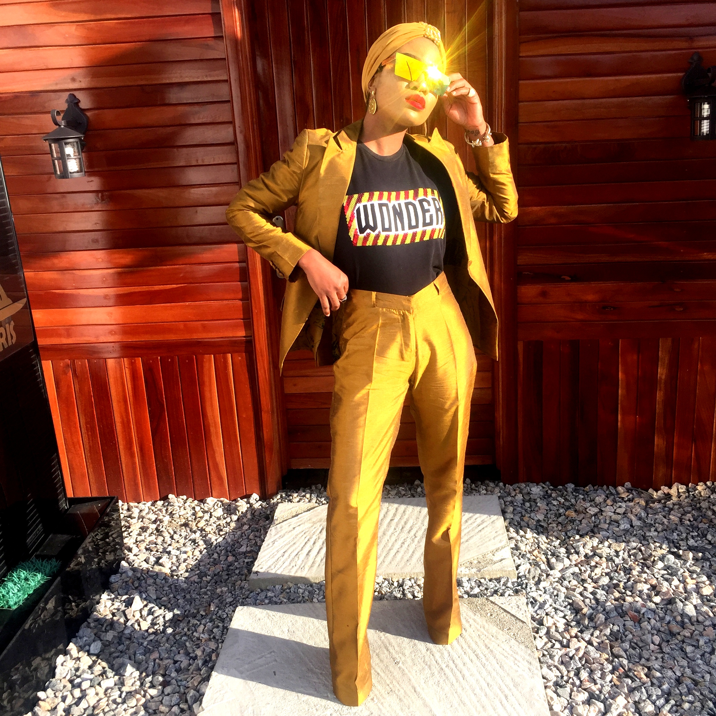 Nigerian fashionista jennifer oseh, theladyvhodka in a gold two piece metallic suit and mirror sunshades