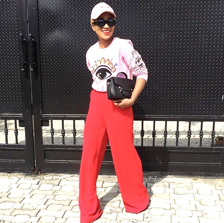 Nigerian fashionista jennifer oseh, theladyvhodka in red flared pants and a pink sweat shirt