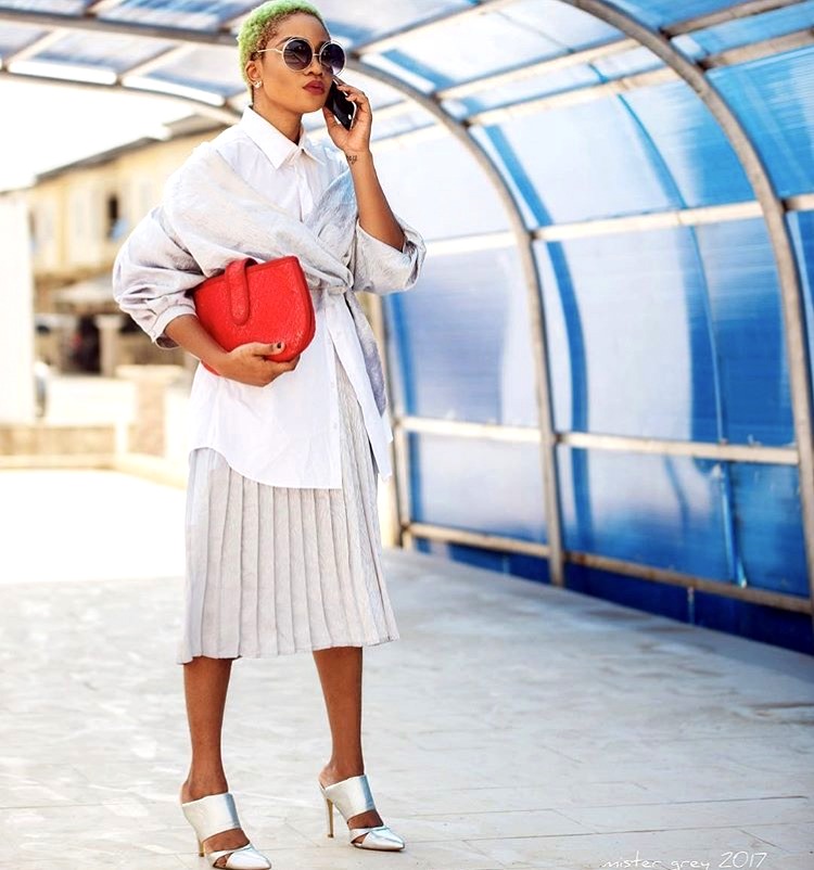 Nigerian style influencer Jennifer Oseh - Theladyvhodka in white shirt and pleated skirt