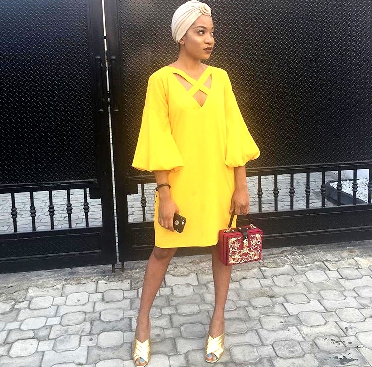Nigerian fashionista jennifer oseh, theladyvhodka in a yellow shift dress and turban
