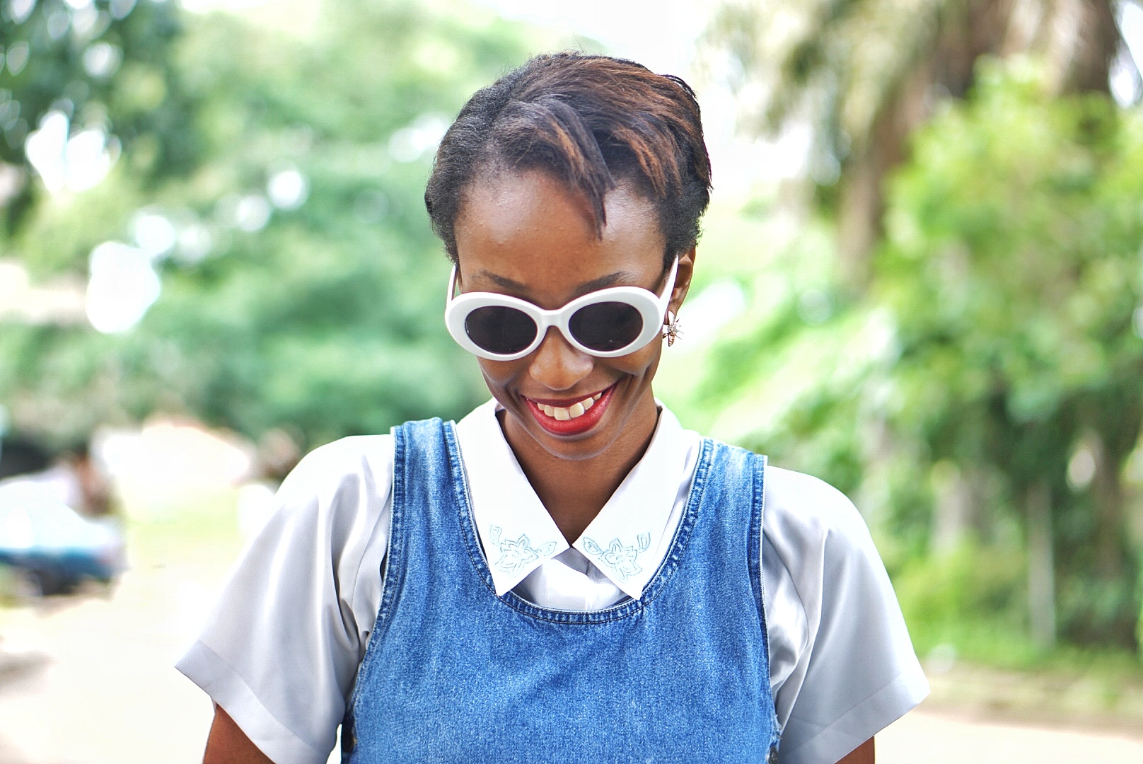Nigerian fashion blogger Cassie Daves smiling with kurt cobain sunshades on