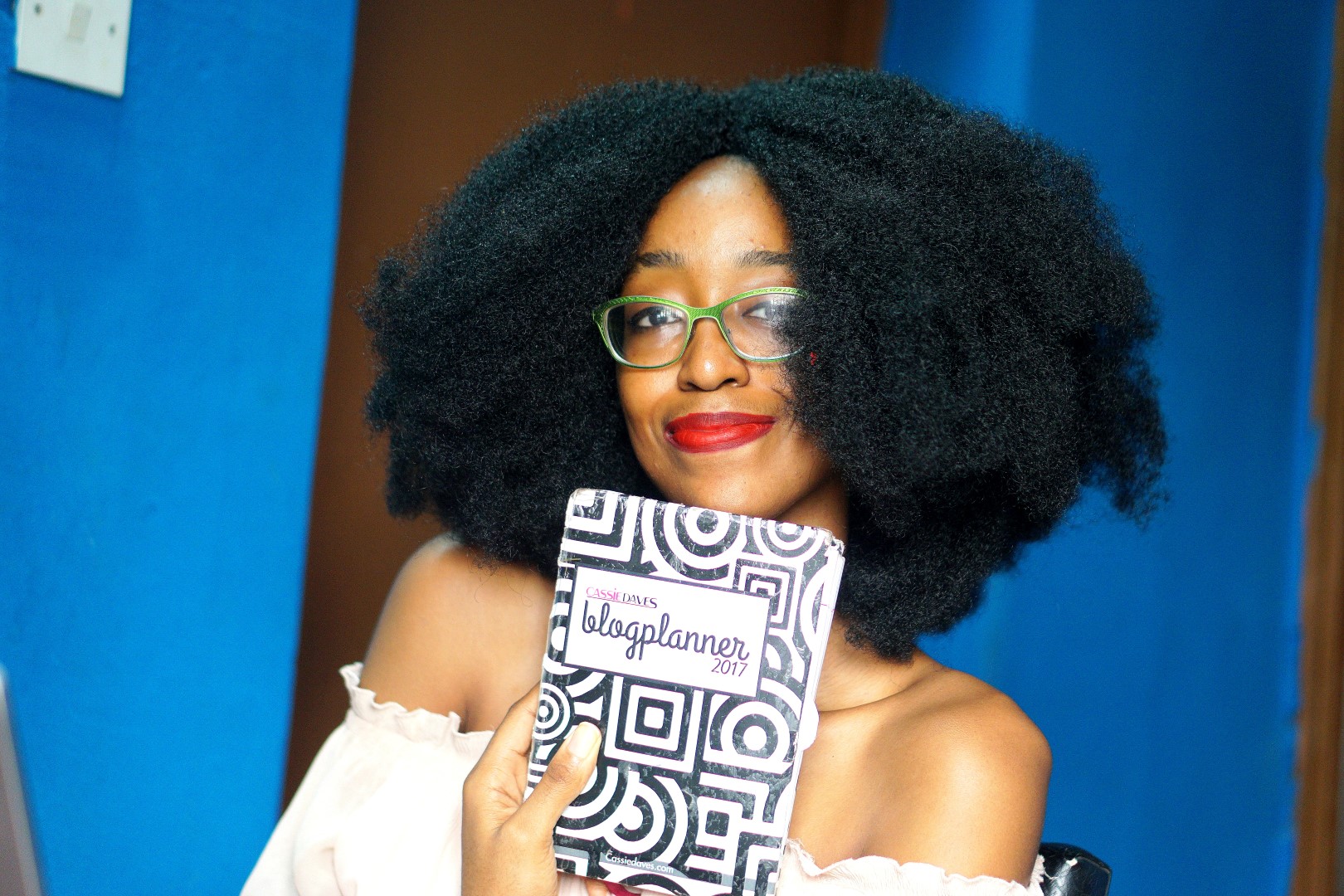 Nigerian fashion blogger cassie daves holding up the cassie daves blog planner