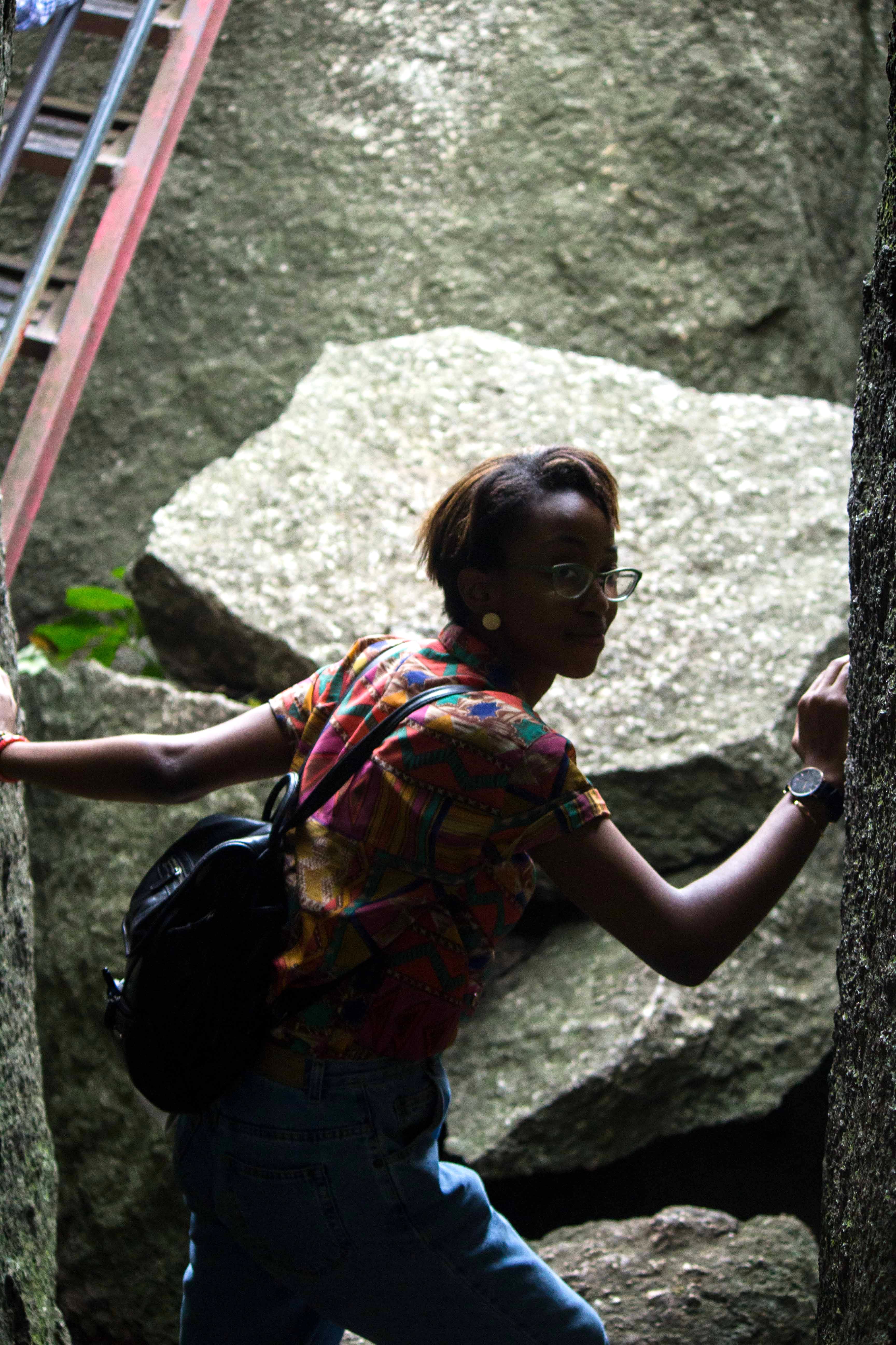 Blogger Cassie Daves climbing the olumo rock, places to visit in abeokuta