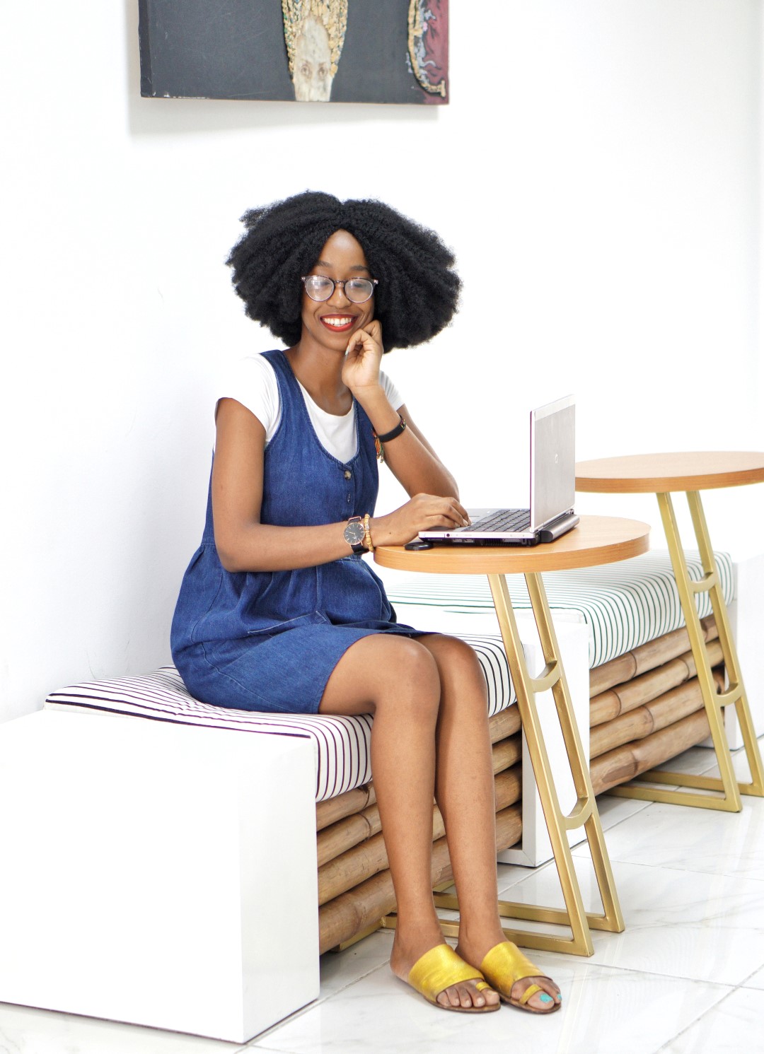 Nigerian blogger Cassie Daves smiling over a laptop at tribe xx lab, overcoming blogger block