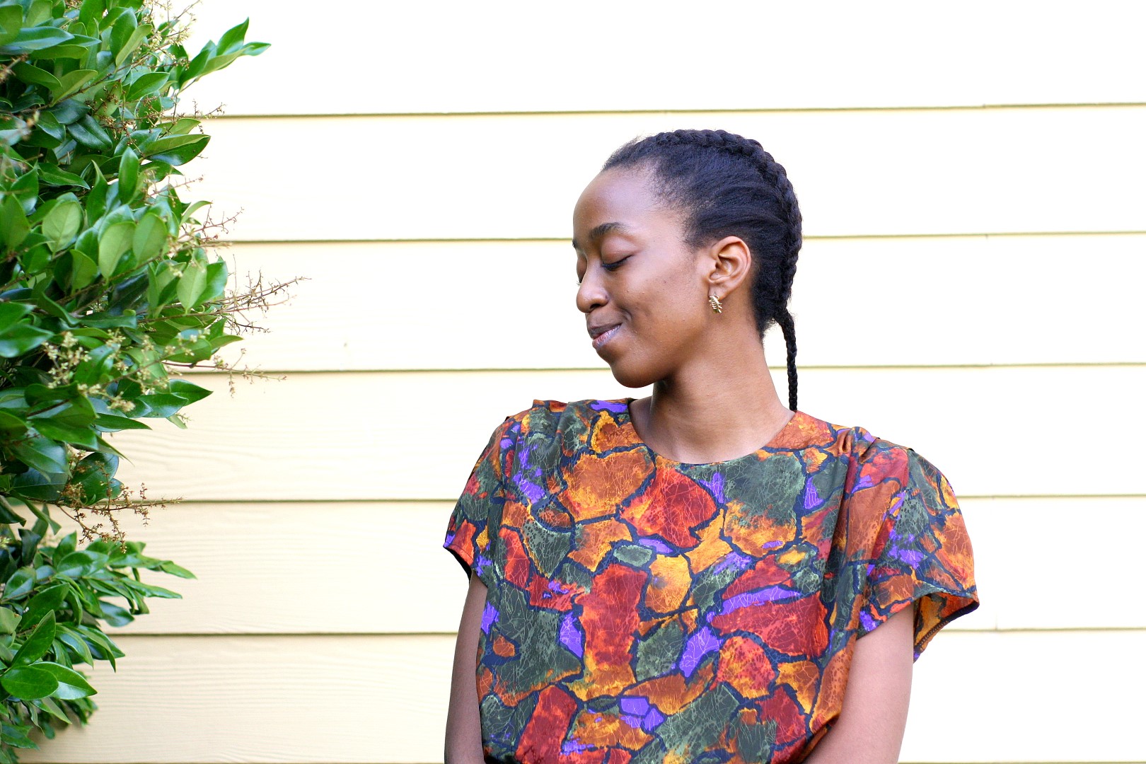 Going back to the basics - Nigerian fashion blogger Cassie Daves in a profile shot wearing a bright coloured prints top