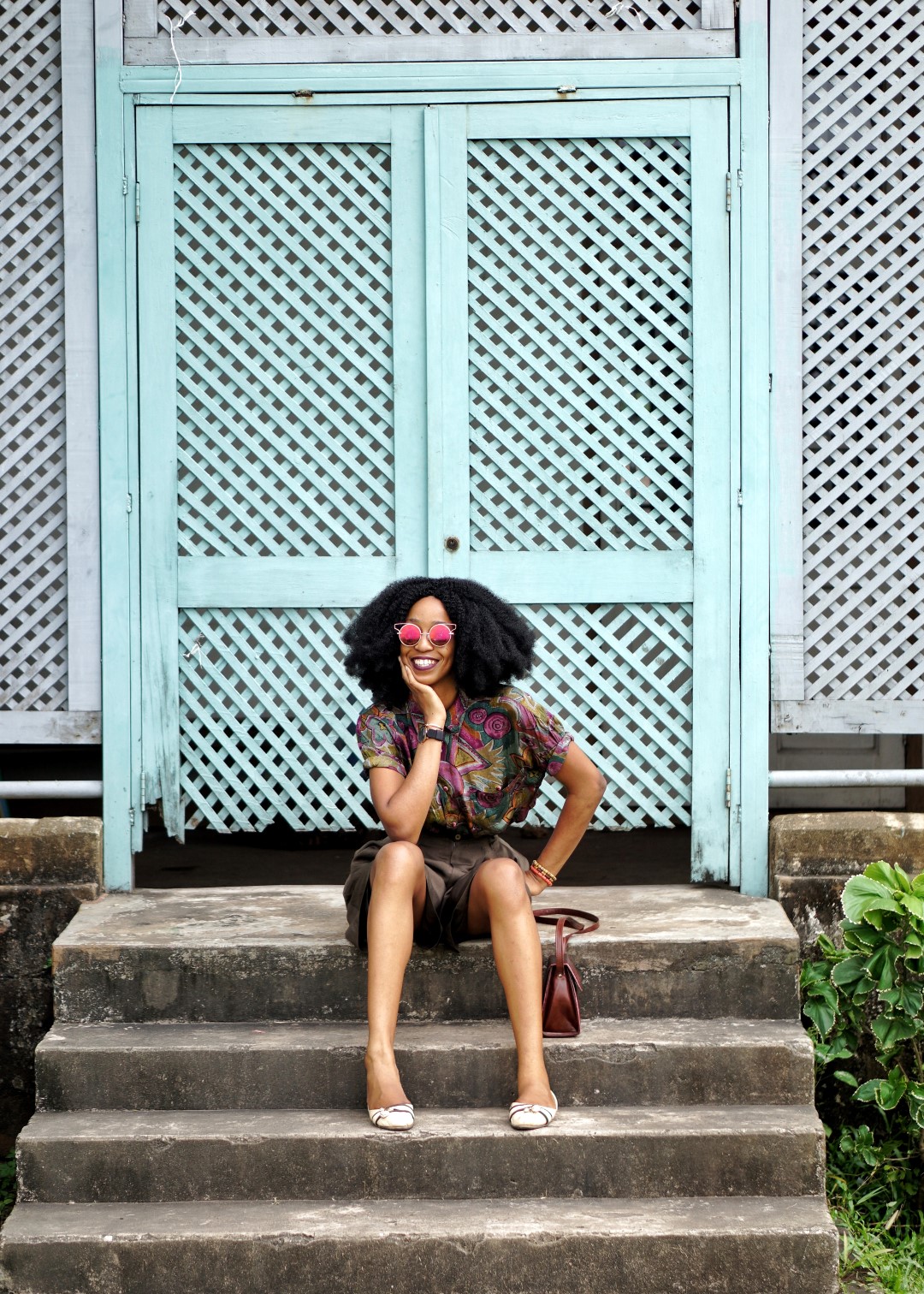 Nigerian blogger Cassie Daves sitting on a stairs in jaekel house lagos