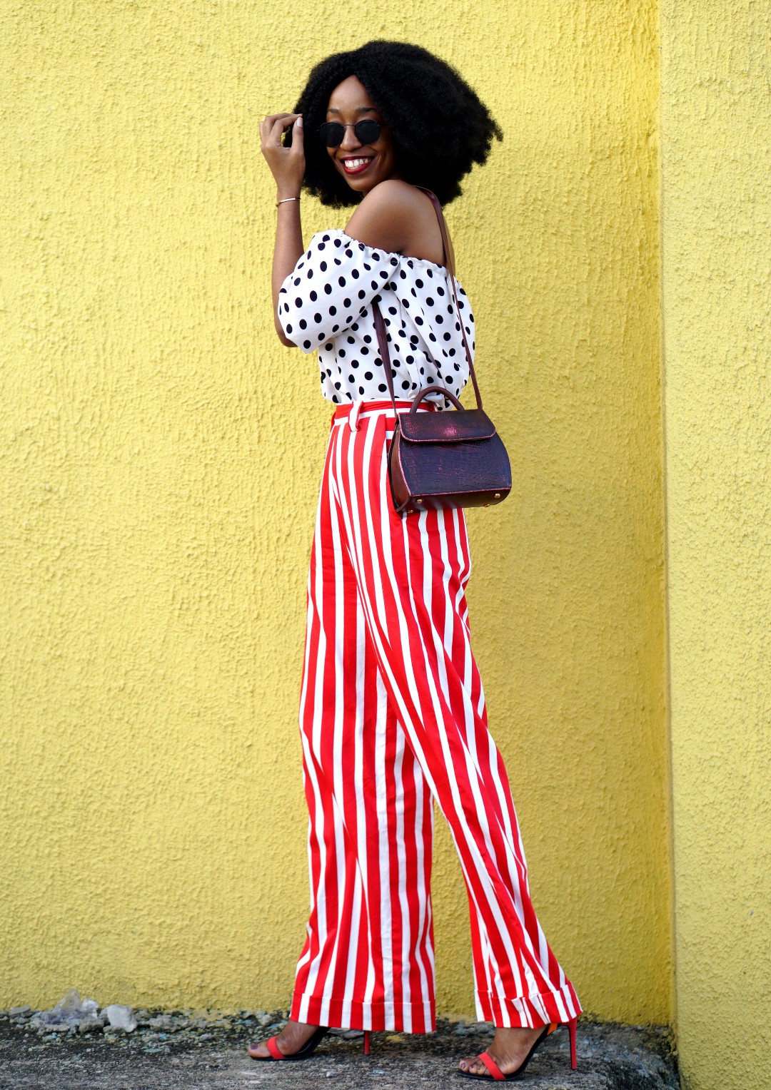 Mixed prints fashion trend : Blogger Cassie Daves In a polka dot off shoulder top and striped pants