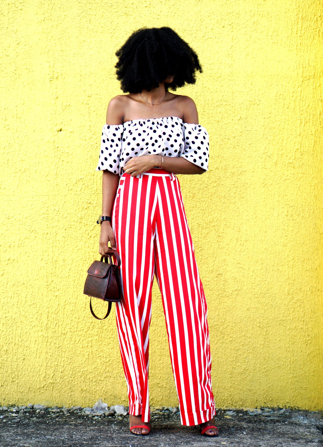 Mixed prints fashion trend : Nigerian blogger Cassie Daves In a polka dot off shoulder top and striped pants