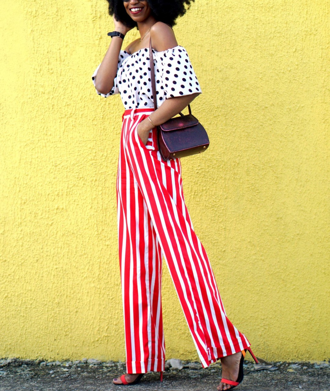 Mixed prints fashion trend : Nigerian fashion blogger Cassie Daves In a polka dot off shoulder top and striped pants