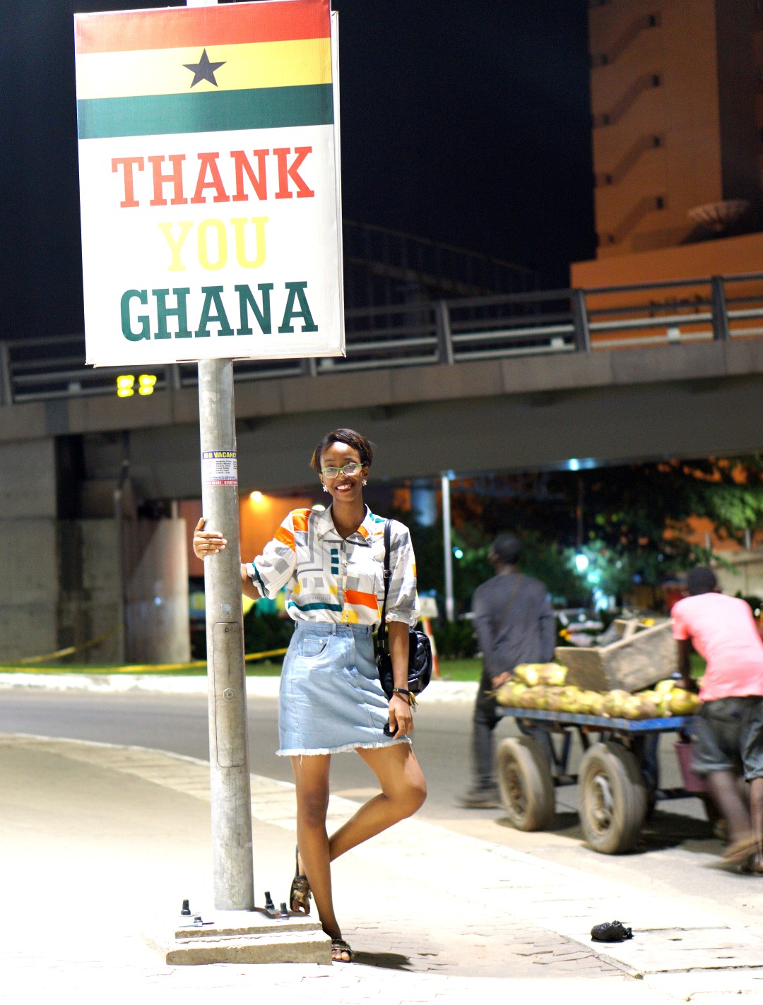 Nigerian blogger Cassie Daves standing at a sign post in Accra Ghana, Things to do In Accra