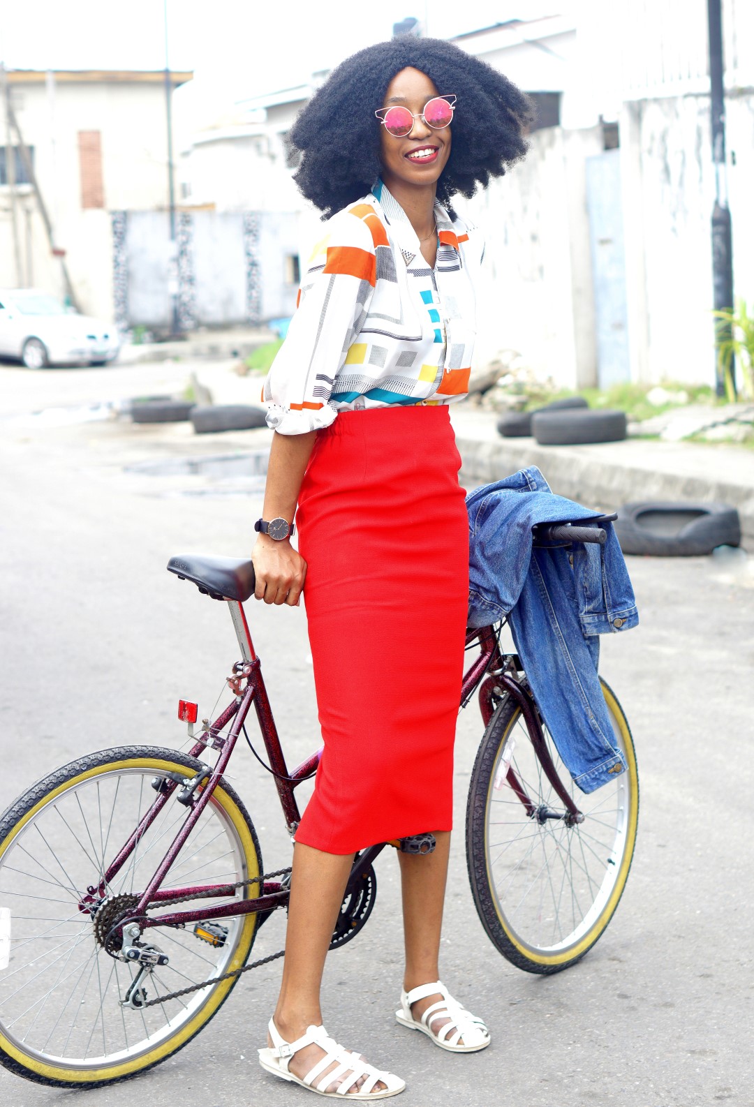 Nigerian fashion blogger Cassie Daves in Red midi pencil skirt, vintage print shirt and denim jacket