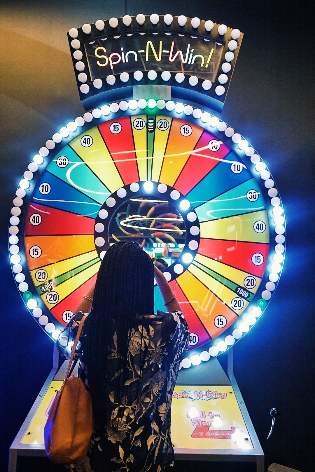 Girl playing spin the wheel at rufus and bee