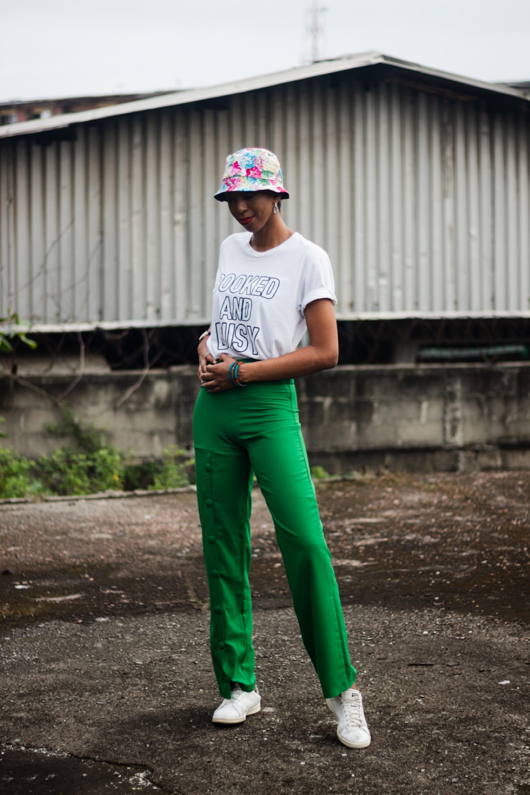Cassie daves in a bucket hat, tee and green pants from wawooh hq