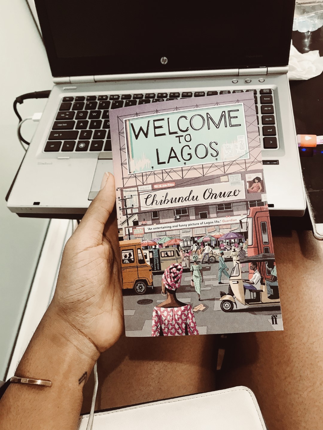 Cassie Daves Nigerian blogger holding the book welcome to lagos by chibuzo onuzo