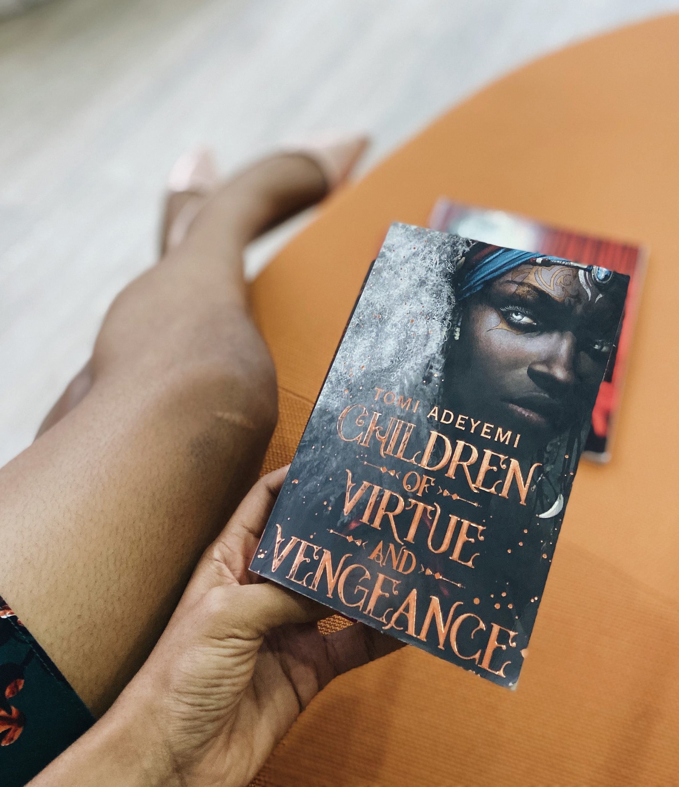 Cassie Daves Nigerian blogger holding the book children of virtue and vengeance
