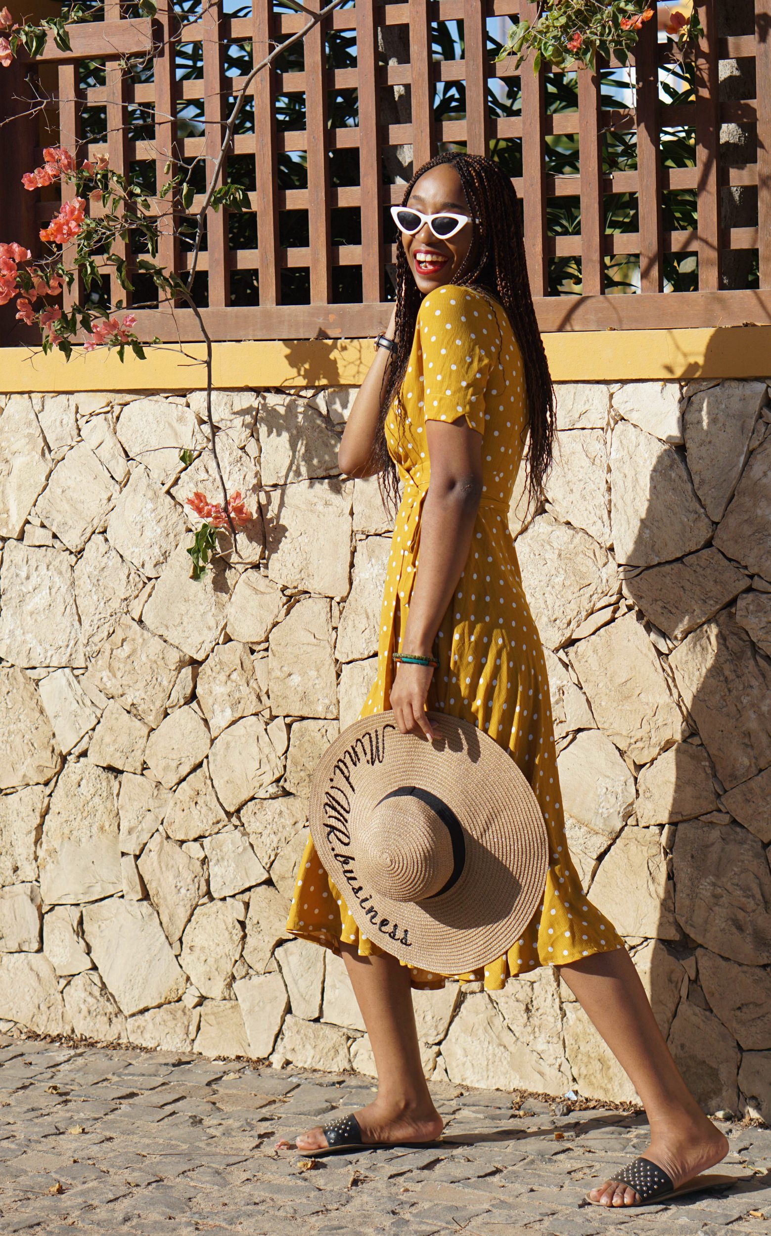 Nigerian lifestyle blogger Cassie Daves wearing a yellow polka dot dress 
