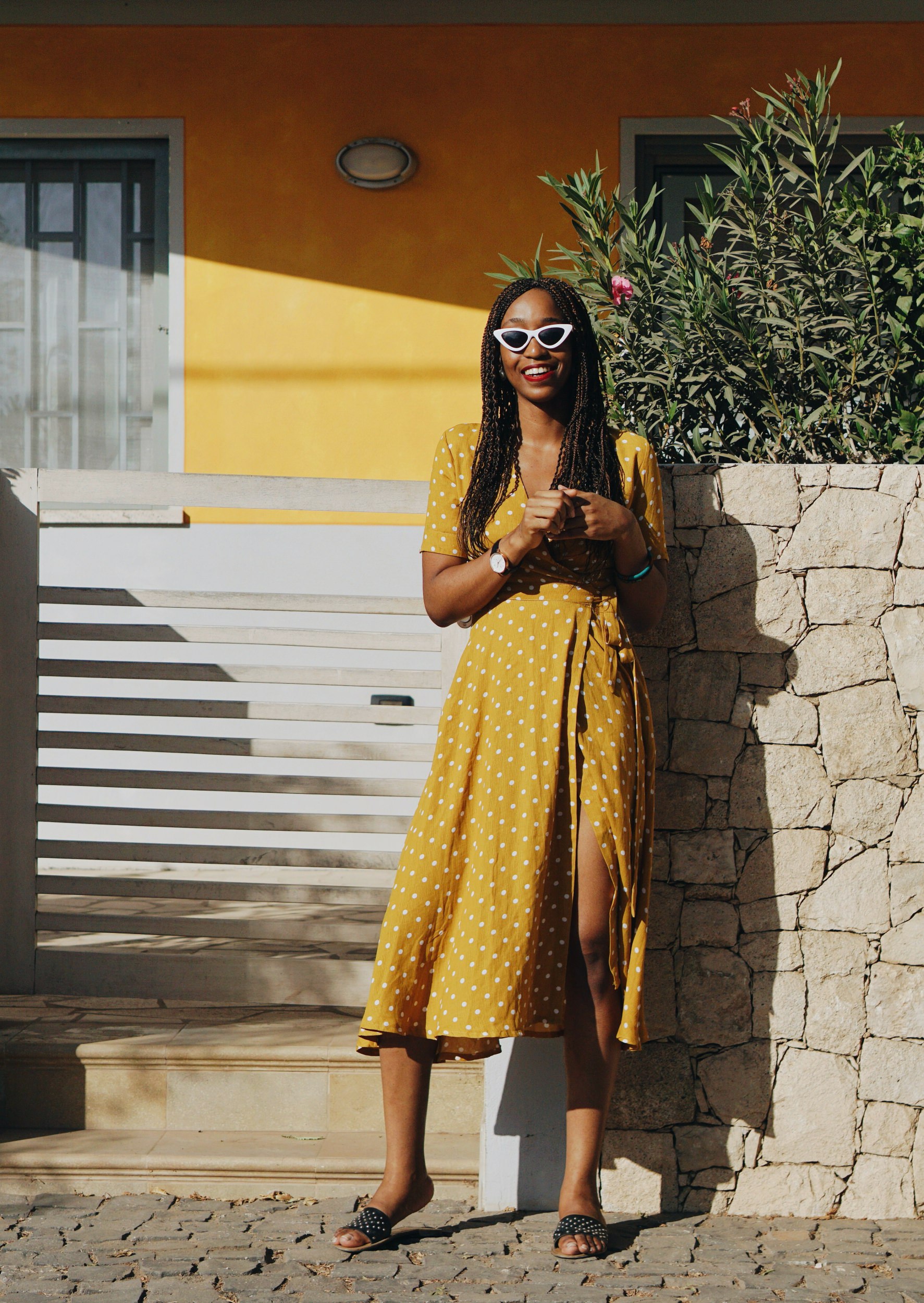 Cassie Daves wearing a yellow polka dot dress on the streets of Santa Maria, cape Verde 