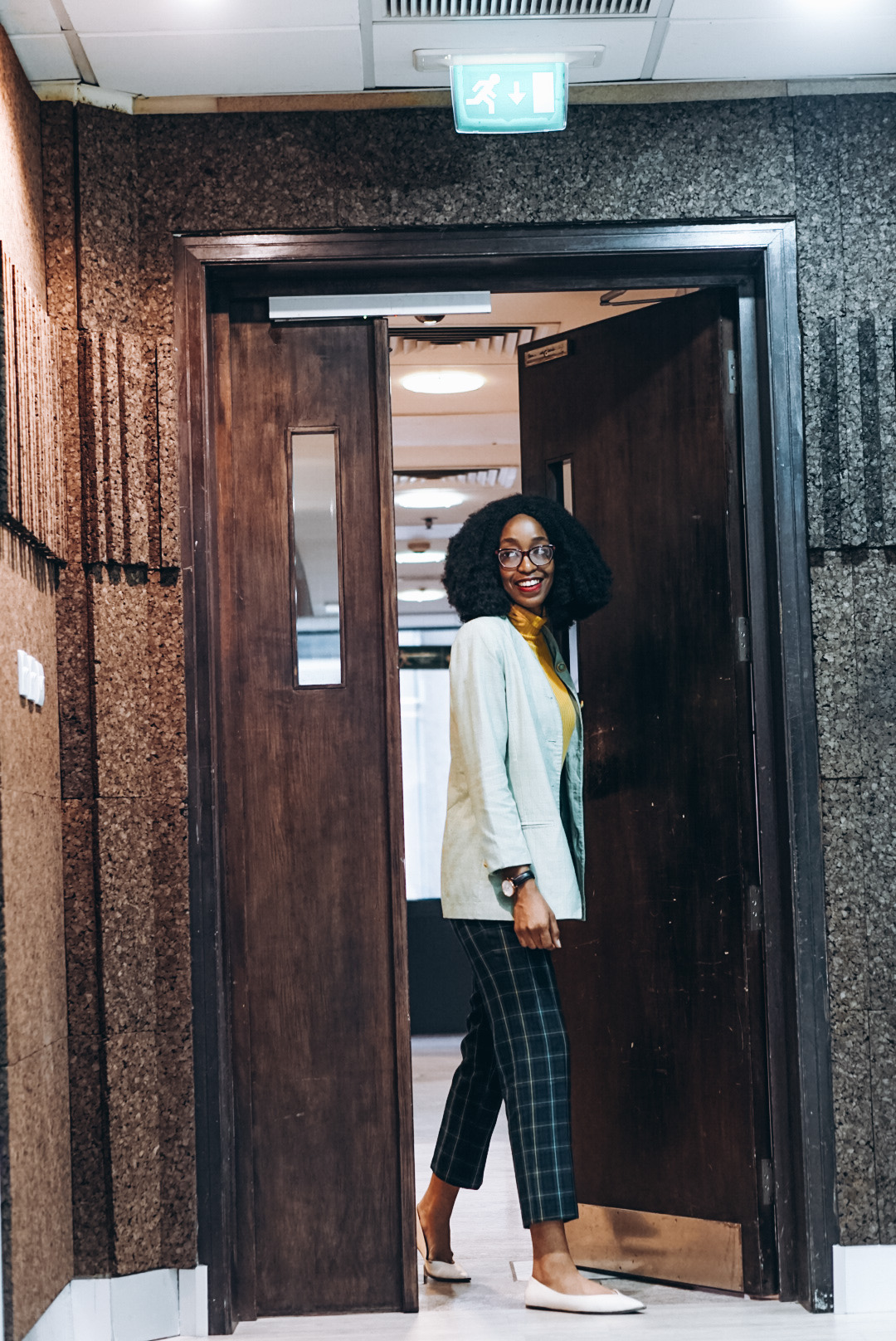 Nigerian fashion blogger Cassie Daves wearing oversized plaid vintage blazer, and blue - green plaid cropped pants