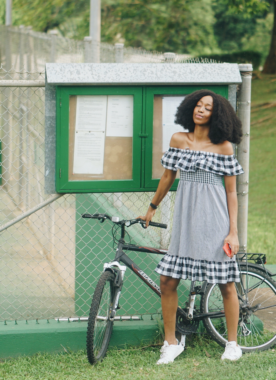 Lifestyle blogger Cassie Daves standing with a bicycle at IITA Ibadan