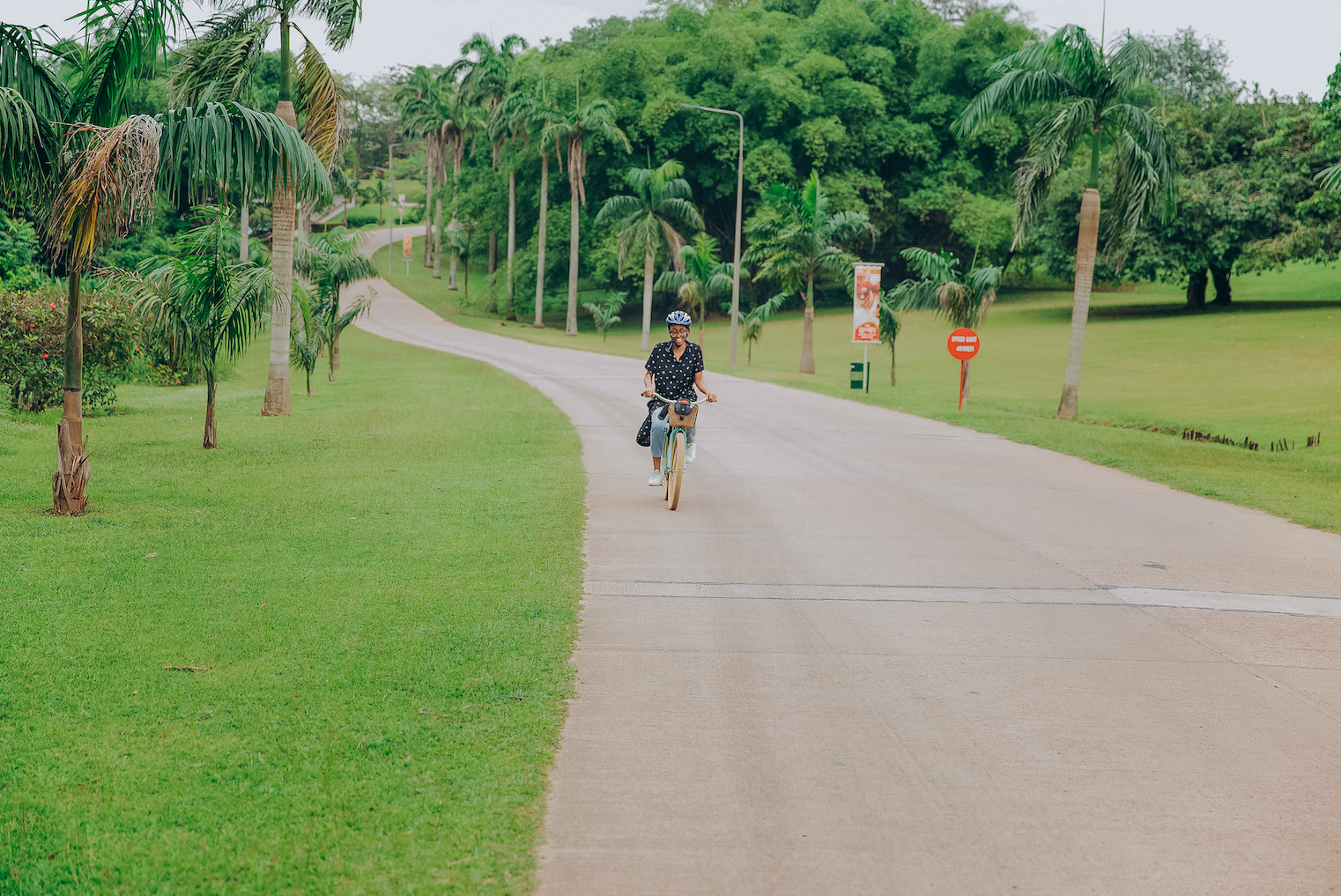 Cassie Daves riding a bicycle at IITA hotel ibadan